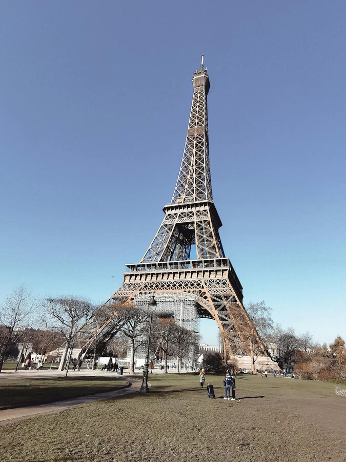 The Eiffel Tower seen from below at golden hour with warm light