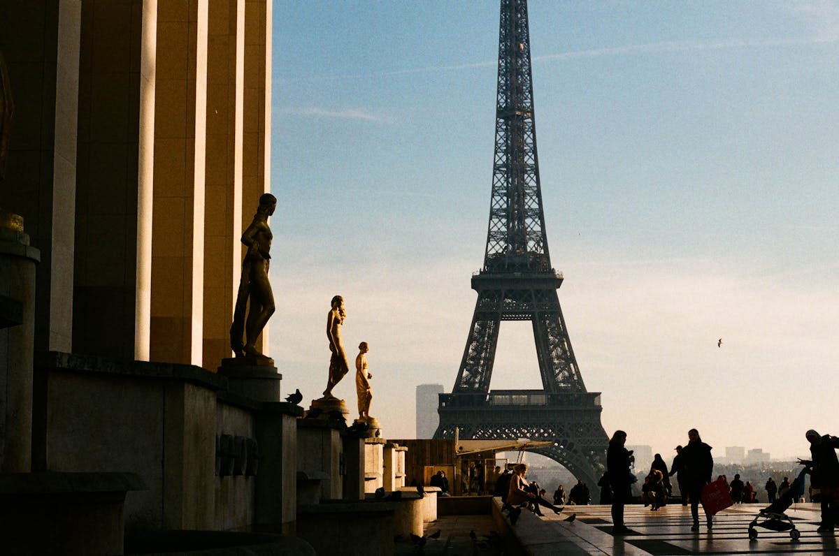 Silhouette of a couple standing near the Eiffel Tower at sunset