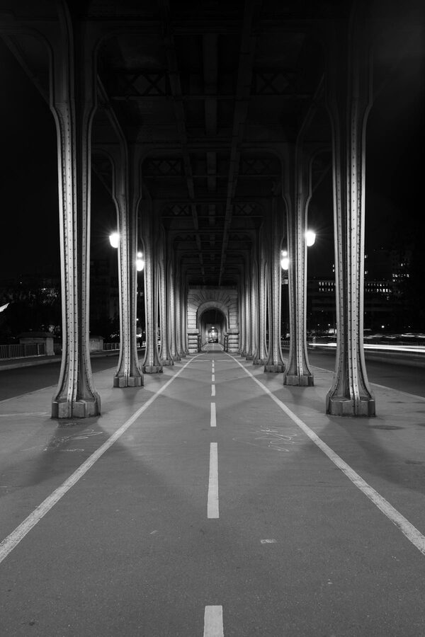 View of the Eiffel Tower from the columns of Pont de Bir-Hakeim bridge in Paris