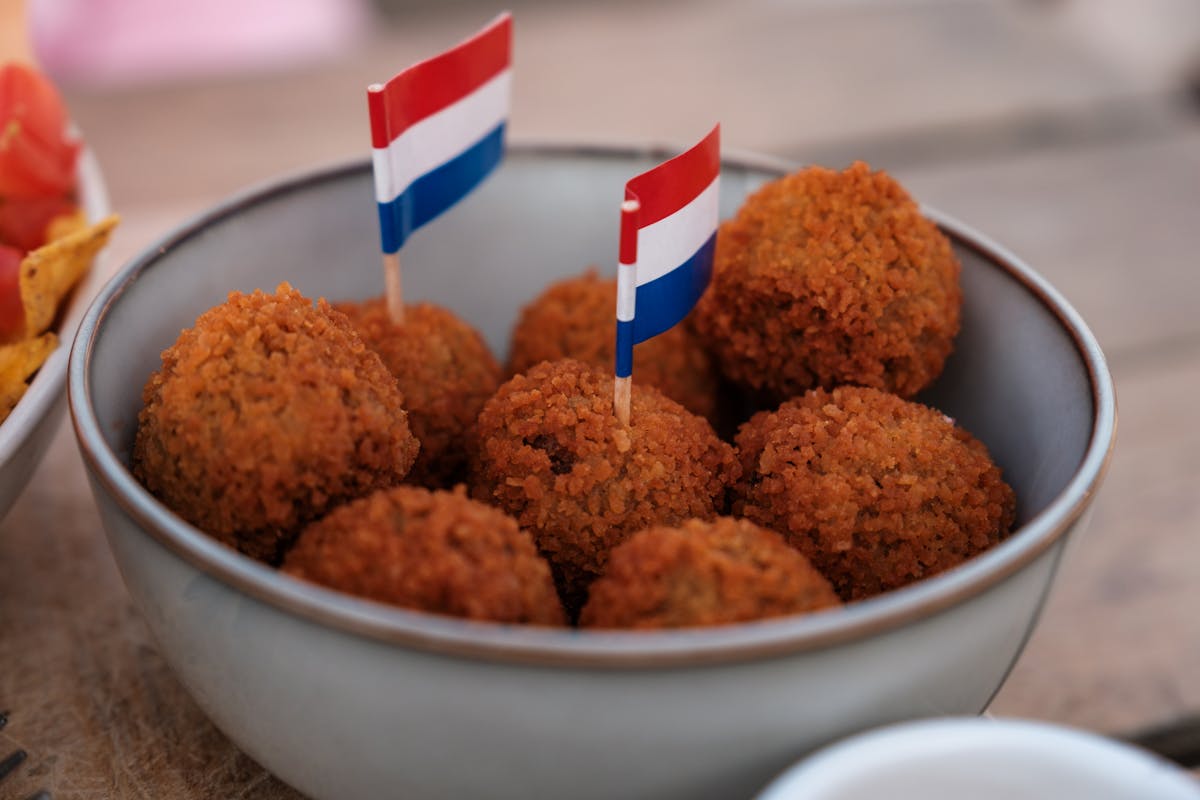 Bowl of Dutch bitterballen with mini flags on a cafe terrace