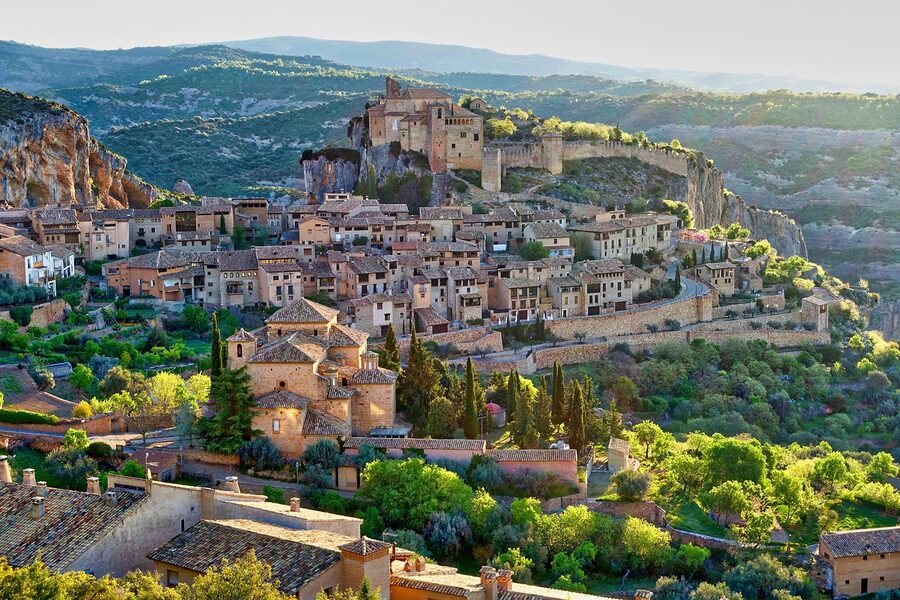 Panoramic view of a hilltop village overlooking the Mediterranean countryside