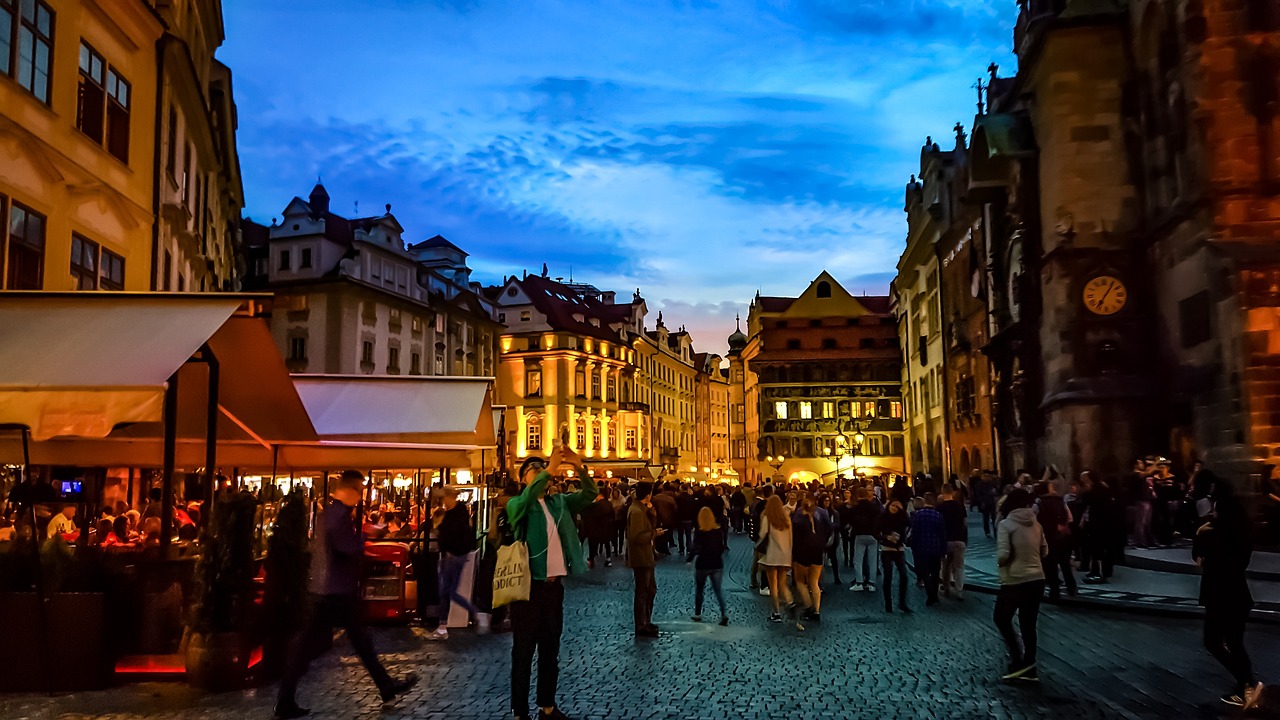 Prague old town square with cafes and restaurants lit up at evening
