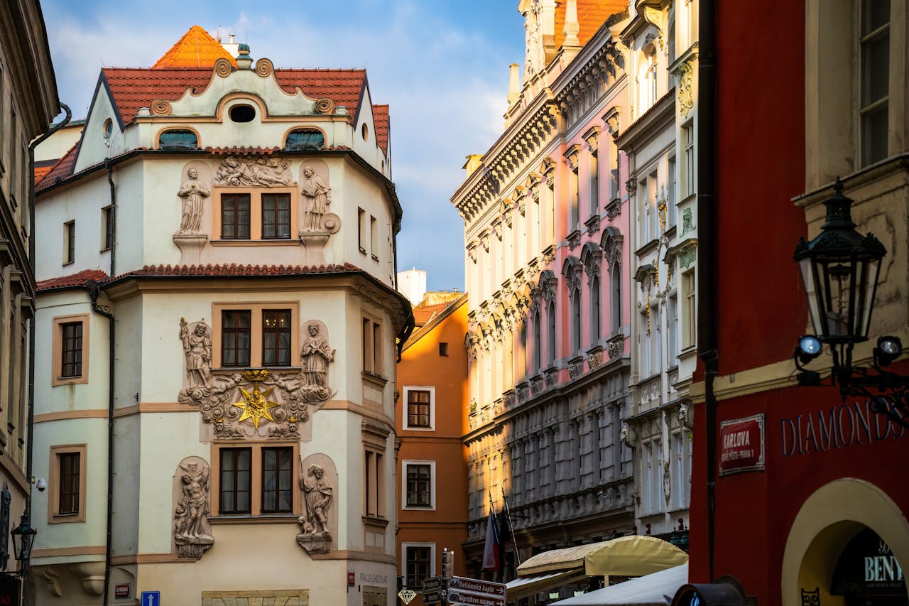 Historic Prague street with ornate facades in golden sunlight