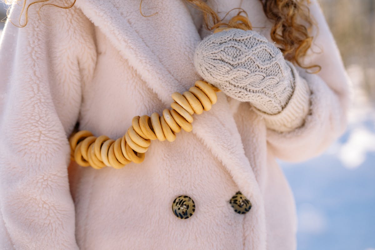Cozy winter fashion featuring beige coat and knit mittens