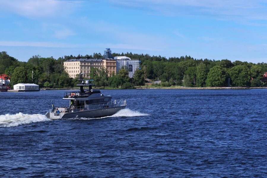 Boat cruising through picturesque waters of Stockholm with lush greenery