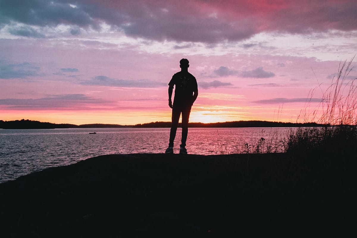 Silhouette of a person by the Stockholm waterfront at sunset