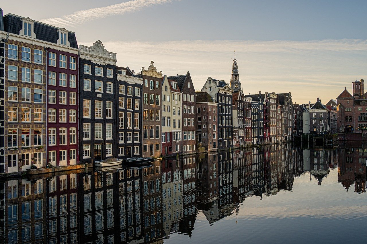 Amsterdam canal houses with water reflection in the Netherlands