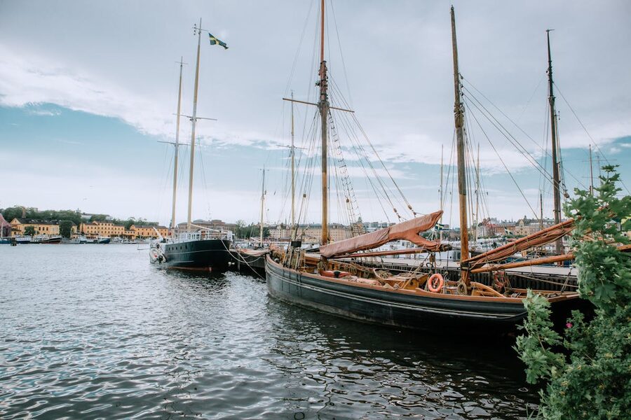 Historic sailboats moored in Stockholm Harbor on a cloudy day