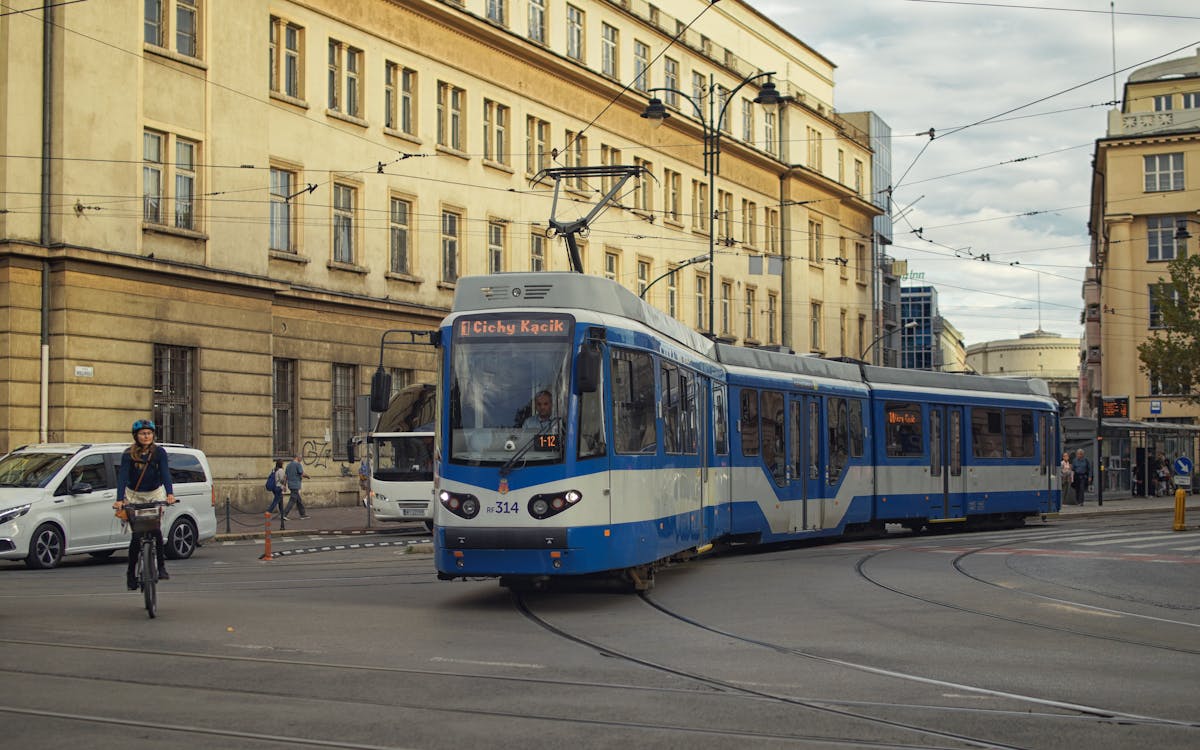 Blue tram navigating the streets of Krakow Poland with urban architecture