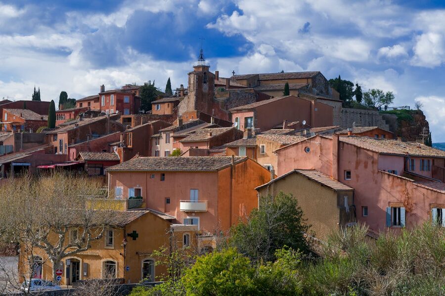 The ochre-colored village of Roussillon in Provence under a blue sky