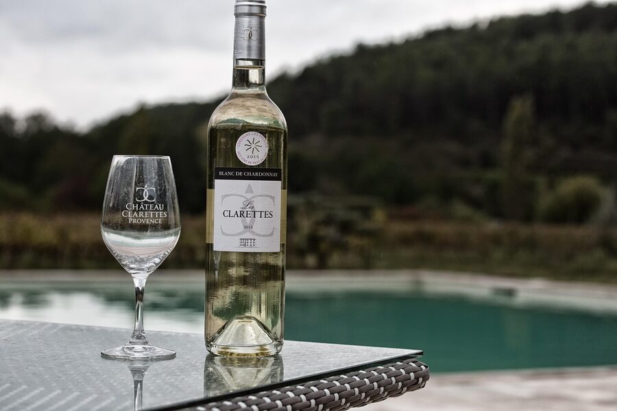 Wine tasting setup with bottles and glasses at a vineyard