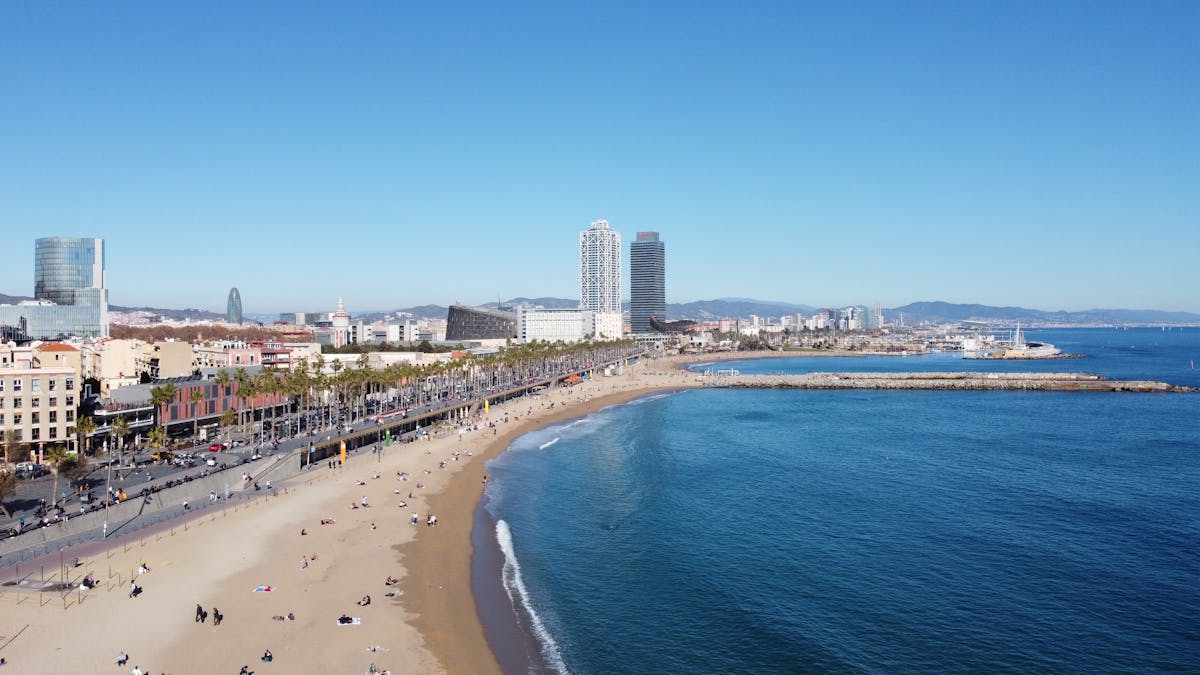 Aerial view of Barcelona beach with the city skyline on a clear day