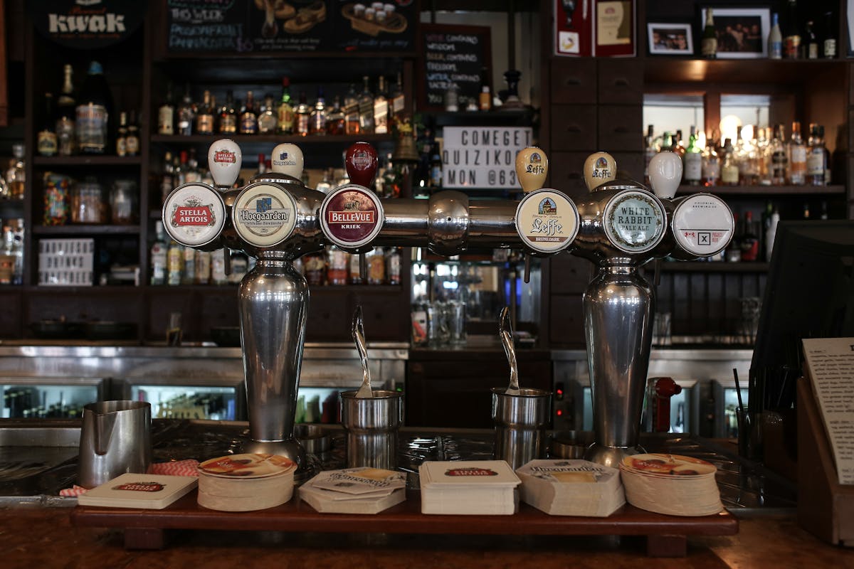 Beer taps showcasing various brands in a stylish pub interior