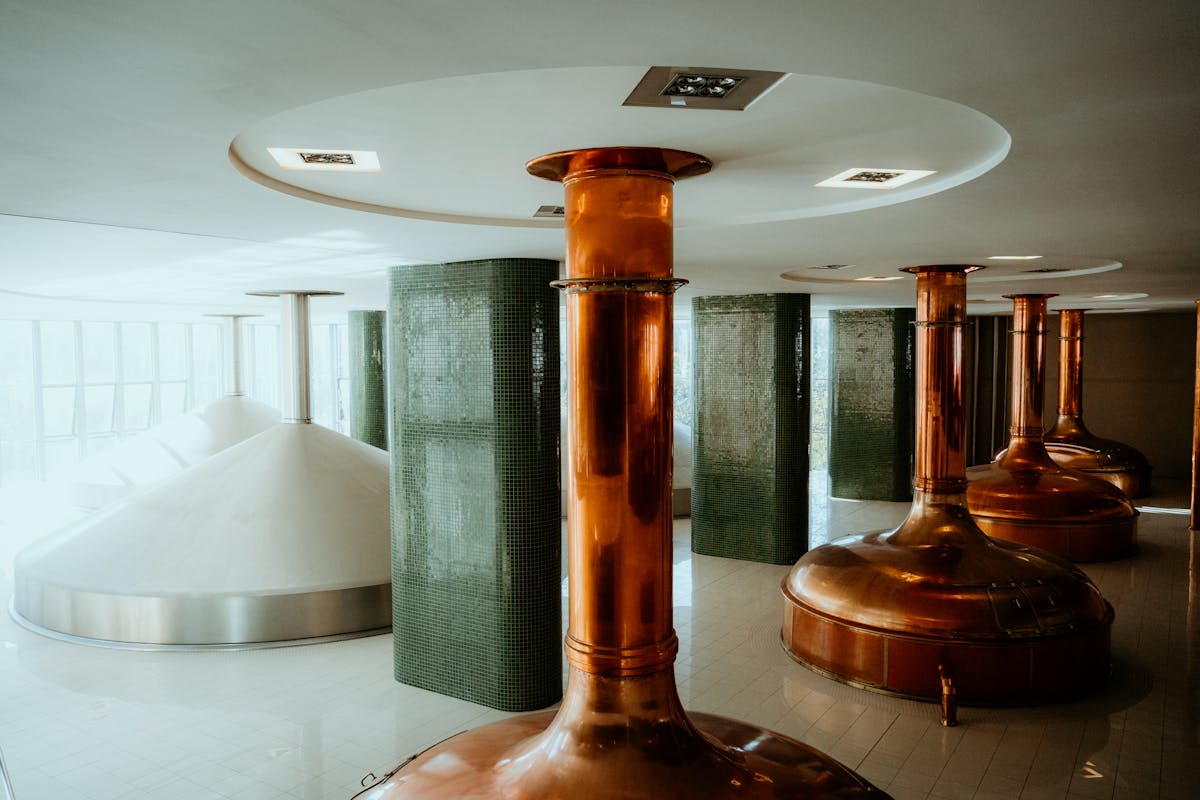 Interior view of a brewery with copper tanks and modern brewing equipment