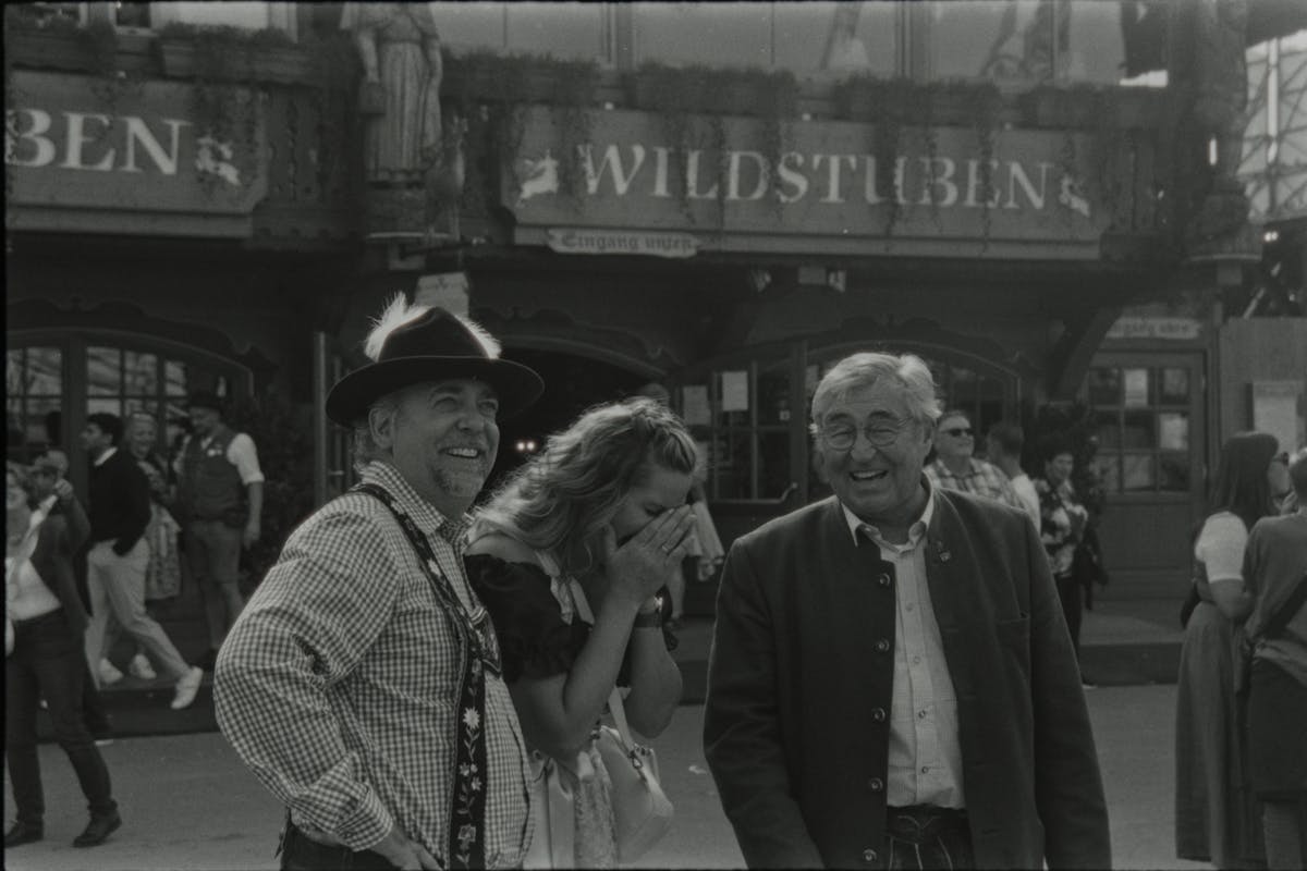 Three people enjoying Oktoberfest at a beer tent in Germany