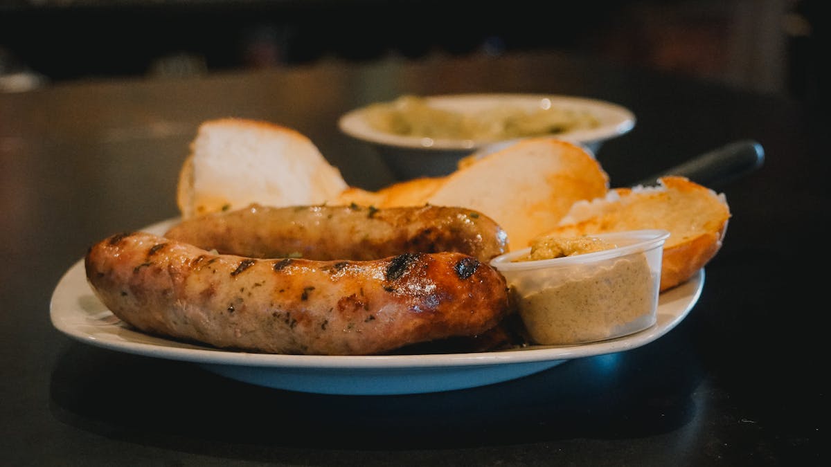 Grilled sausages served with bread and mustard