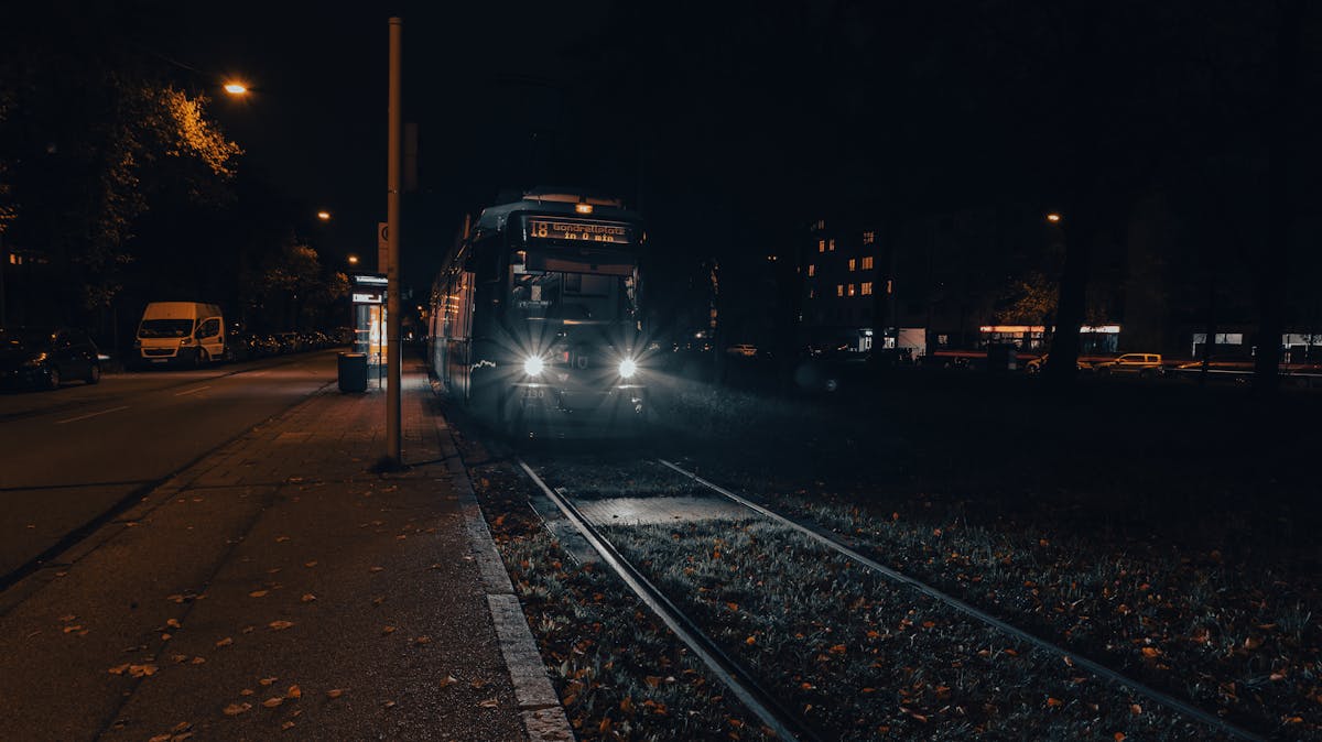 A tram at a stop at night in Munich