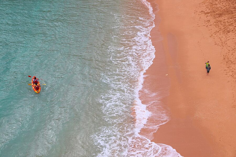 Sea kayakers launching from Praia de Benagil in the Algarve, Portugal