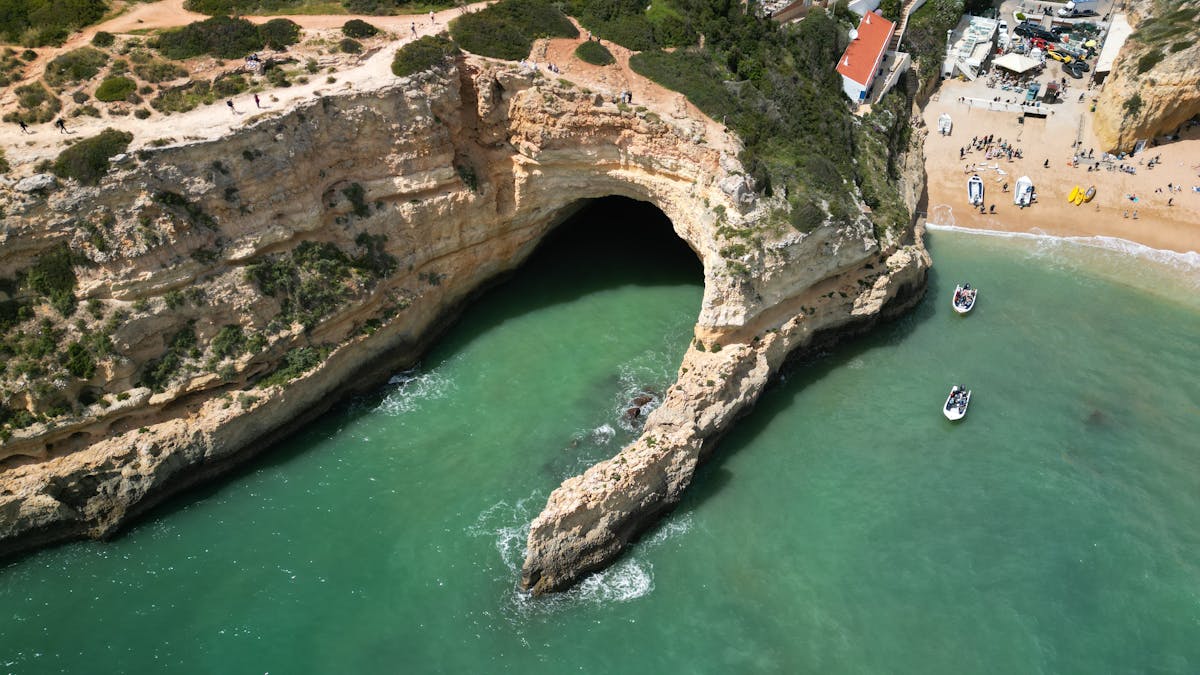 Aerial view of Benagil Cave in the Algarve showing the famous skylight opening and turquoise waters below