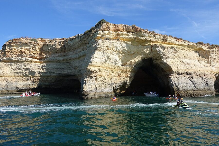 Interior of Benagil Cave with sunlight on the sandy beach