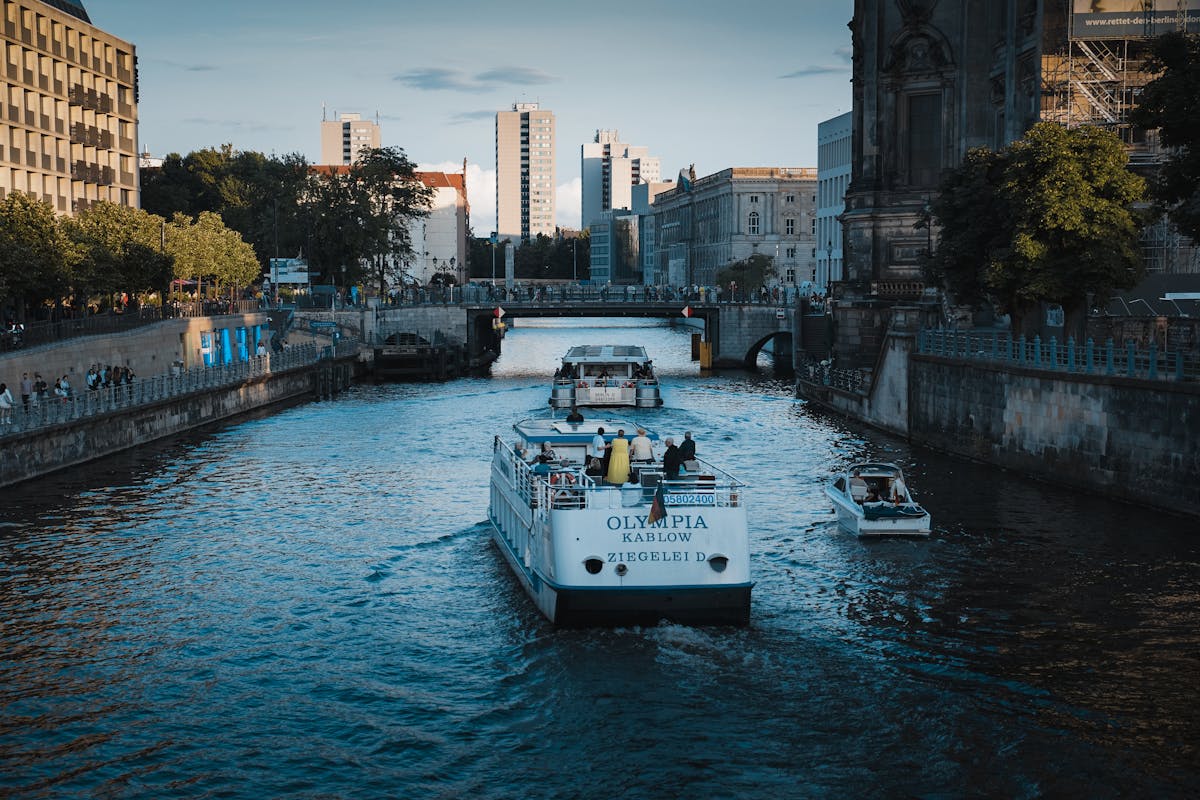 A canal in Berlin with boats and modern architecture