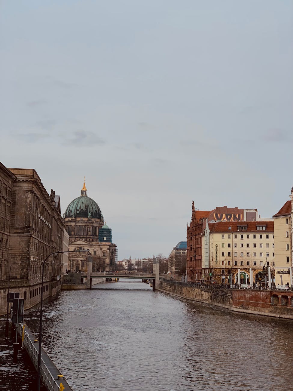 The grand Berlin Cathedral rising above the Spree River on a cloudy afternoon