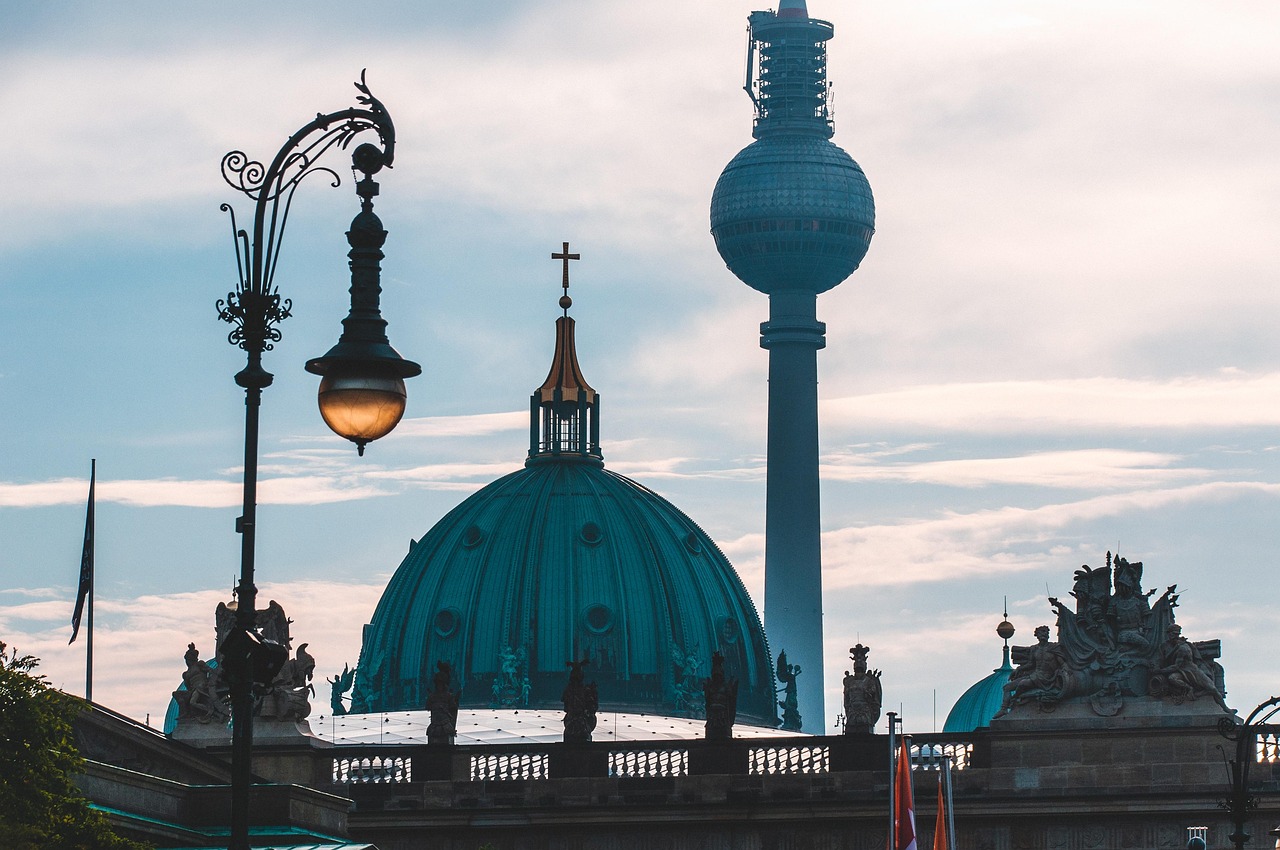 Berlin TV Tower towering above the Berlin Cathedral dome on a clear day