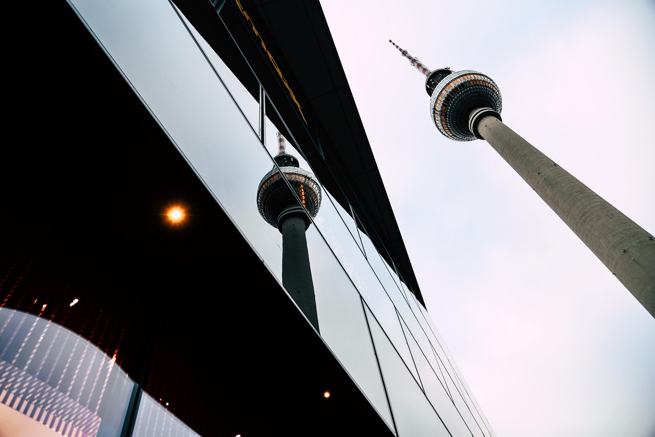 The Berlin TV Tower reflected in a modern glass building at Alexanderplatz