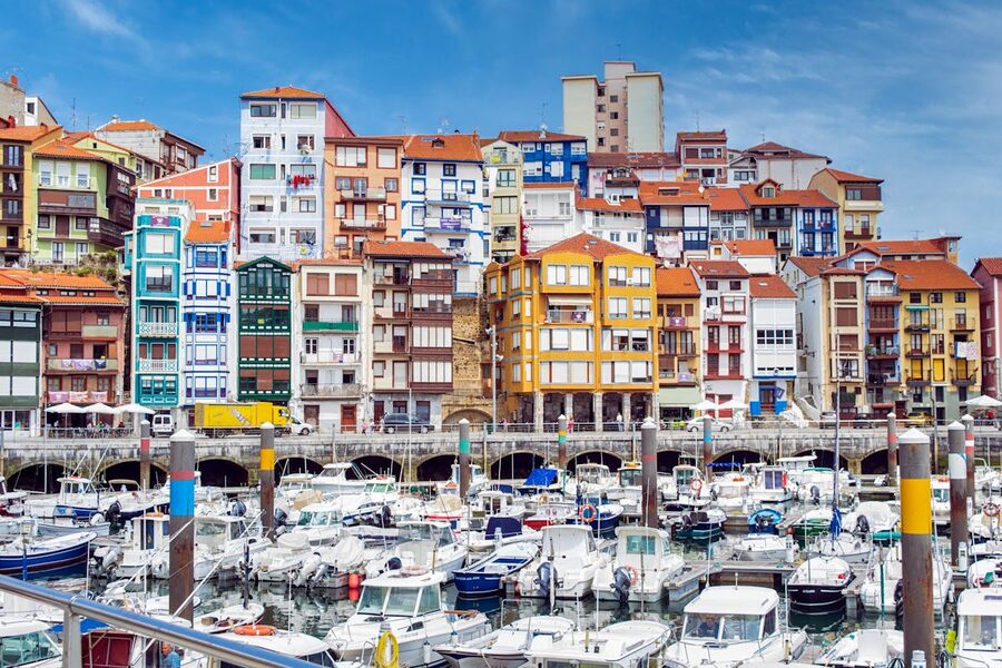 Colorful apartment buildings overlooking the boat-filled marina in Bermeo, Spain