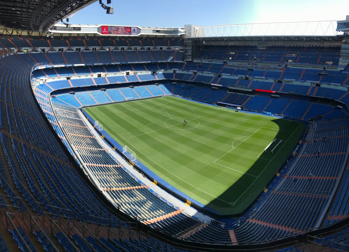 High angle view of the Santiago Bernabeu Stadium pitch and empty stands on a sunny day