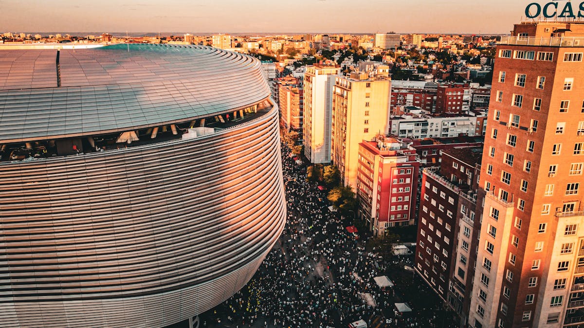 The Santiago Bernabeu Stadium with Madrid's cityscape in the background at sunset