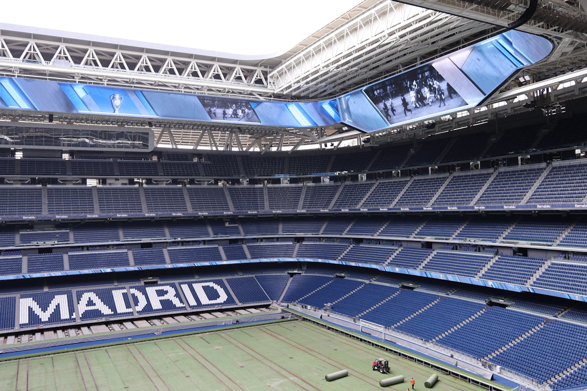 The modern exterior of Santiago Bernabeu Stadium with Real Madrid branding visible