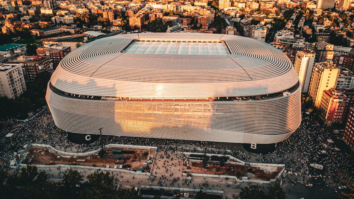 Aerial shot of the Santiago Bernabeu Stadium and surrounding Madrid cityscape at sunset
