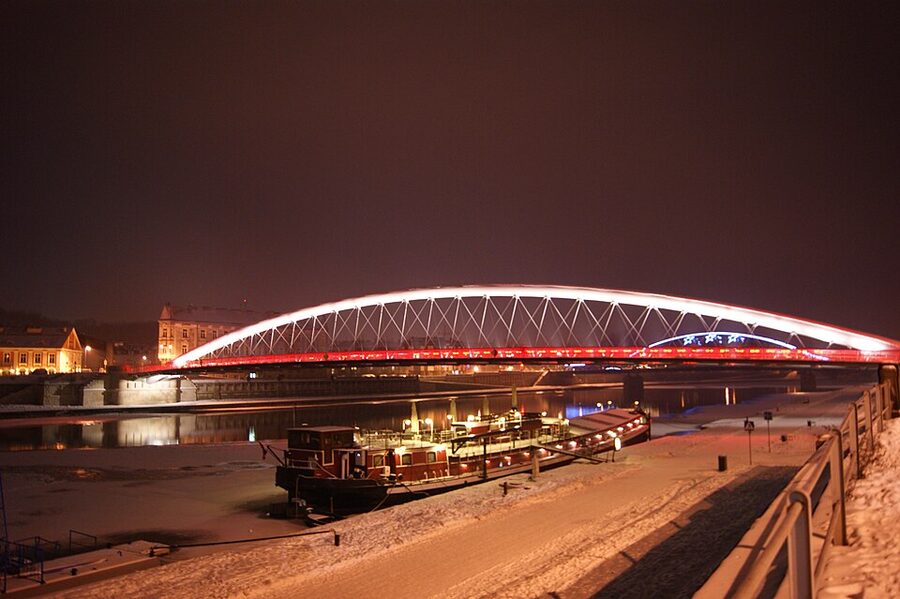 Bernatka footbridge lit up at night over the Vistula in Krakow