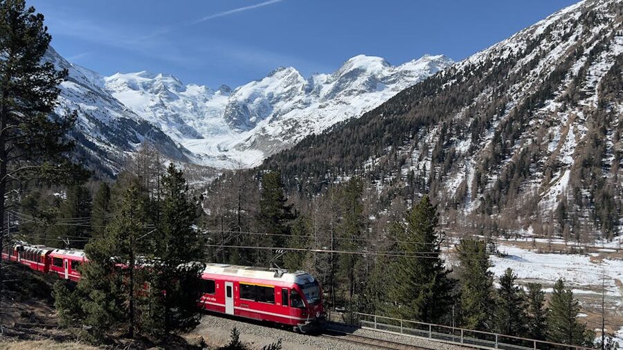 Bernina Express train traversing snowy Swiss Alps