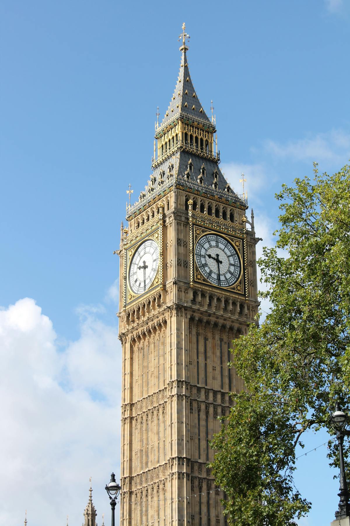 Big Ben clock face framed against a clear blue London sky