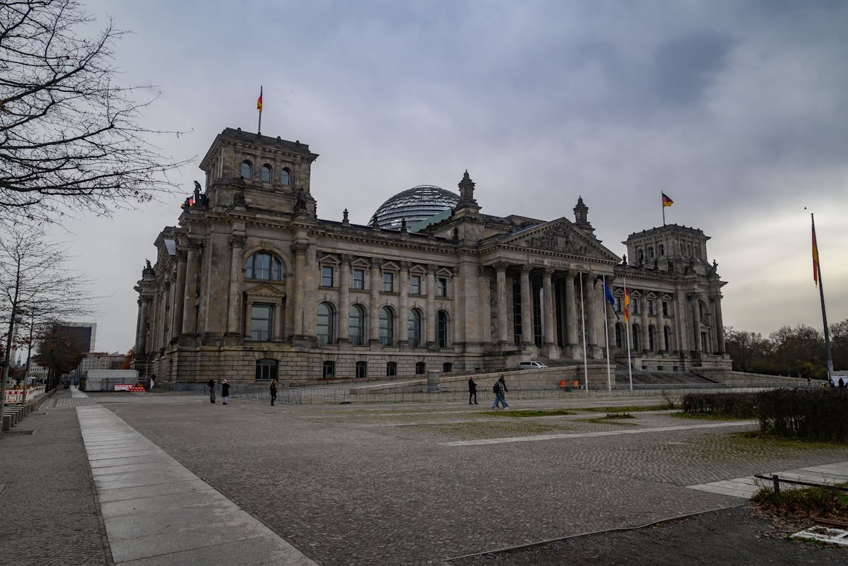 View of the Reichstag building in Berlin under cloudy skies