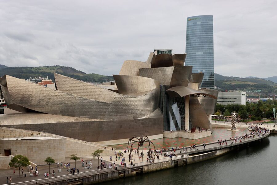 Aerial shot of the Guggenheim Museum and the tall Iberdrola Tower dominating the Bilbao skyline
