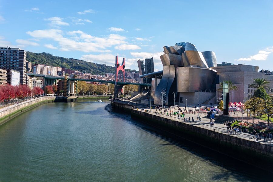 Guggenheim Museum Bilbao alongside the Nervion river and city skyline