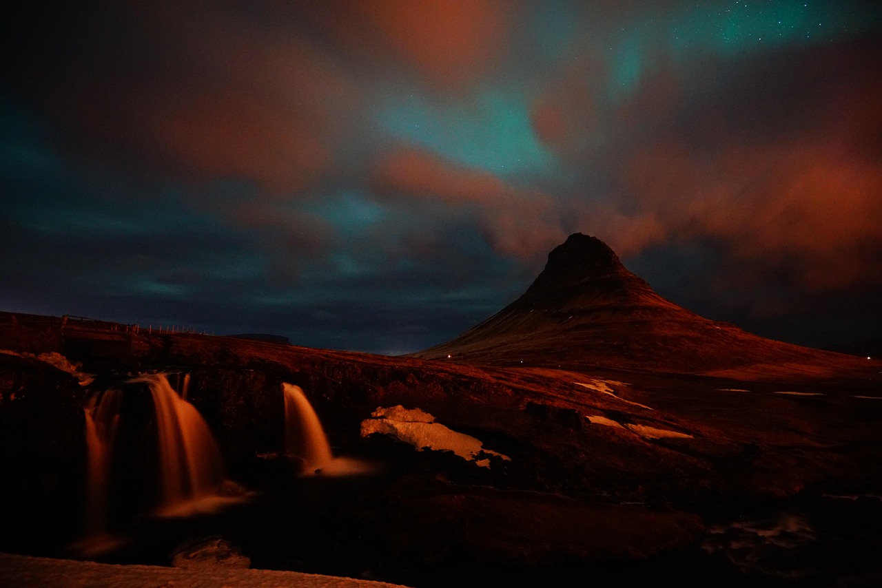 Kirkjufell mountain with waterfall and northern lights in Iceland