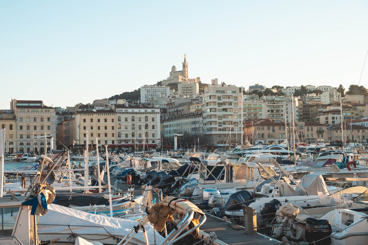Boats in Marseille harbour at sunset with warm golden light