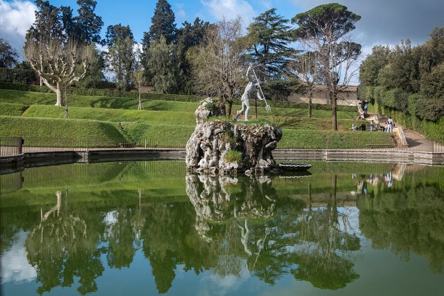 Neptune Fountain reflected in a pool in the Boboli Gardens Florence Italy