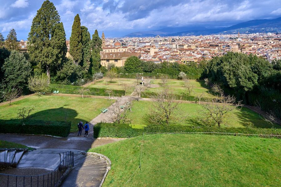 Wide panoramic view of Florence Italy from Boboli Gardens with lush greenery in the foreground