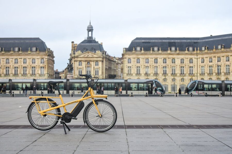 Yellow electric bike in a Bordeaux historic square