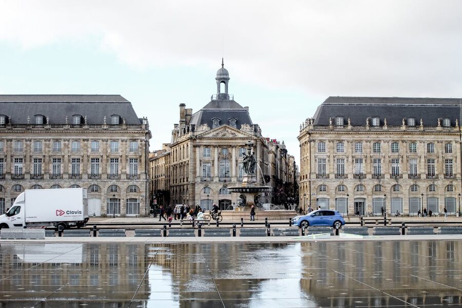 Place de la Bourse in Bordeaux reflected on wet pavement