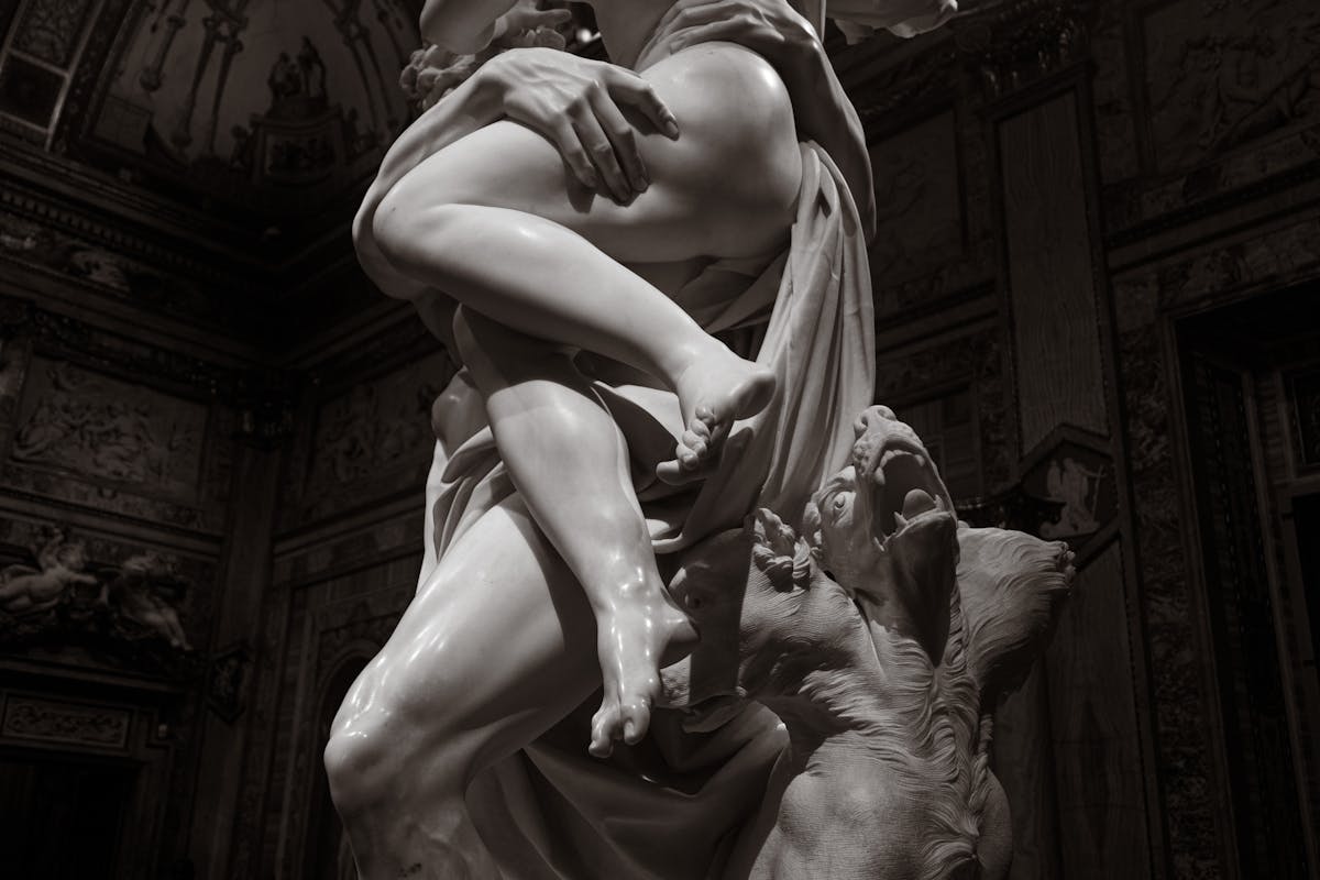 Baroque marble sculpture depicting dramatic classical figures inside the Borghese Gallery in Rome