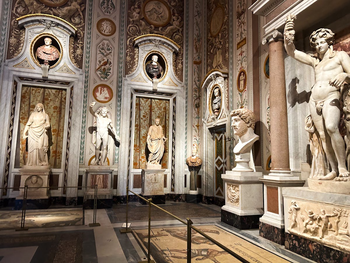 Ancient Roman marble sculptures and ornate decor inside the Borghese Gallery in Rome