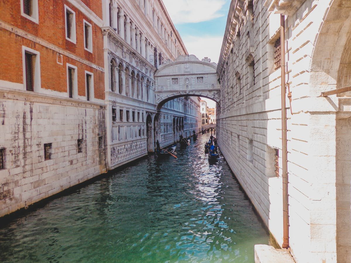 Bridge of Sighs spanning a canal with gondolas beneath in Venice Italy