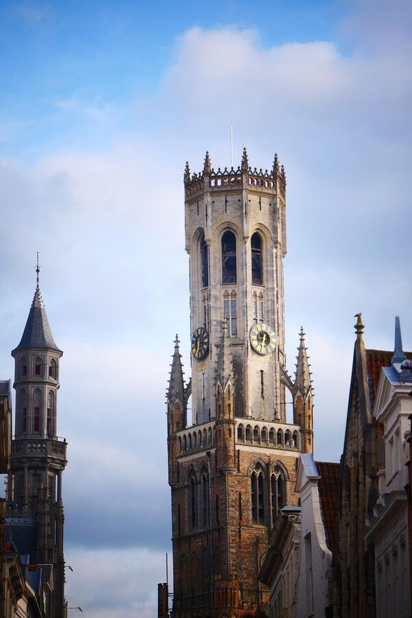 Belfry of Bruges medieval bell tower against blue sky