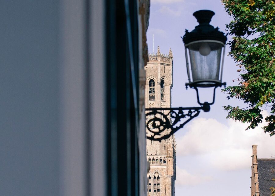 Bruges Belfry tower at night with lamp and atmospheric lighting